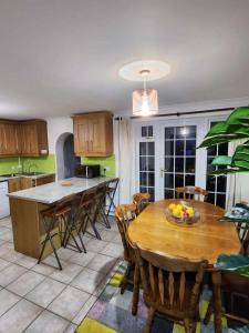a kitchen with a wooden table and chairs in a kitchen at 4 Bedroom home in Buckingham in Buckingham