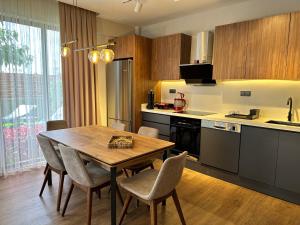 a kitchen with a wooden table and chairs in a room at DrVillaSuits Casa Riva in Belek