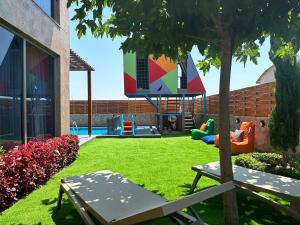 a playground in a yard with a playground at DrVillaSuits Casa Riva in Belek
