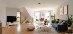 a living room with a blue couch and a tv at Apartment Schlossblick in Illertissen