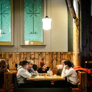 a group of people sitting at a table in a restaurant at La Maison Big Bill in Murdochville