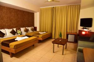 Voodi või voodid majutusasutuse Rajalakshmi Comforts Mysuru toas