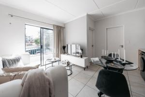 a living room with a couch and a table at Exquisite Getaway - Luxury Apartment in Sandown