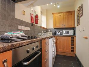 a small kitchen with a sink and a dishwasher at Ty Llugwy in Betws-y-coed