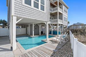 ein Haus mit einem Pool und einer Terrasse in der Unterkunft Blue Diamond by Pier 42 Vacations Oceanfront Luxury for 30 Guests in Holden Beach