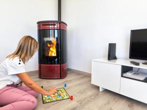a young girl sitting on the floor playing with a game at Apartamento rural en el Berguedà "Lluis & Antonia" A Ac in Sant Jordi de Cercs