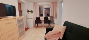 a living room with a couch and a flat screen tv at Dom przy świerku in Elblag