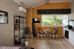a kitchen with a table and chairs in a room at La Bruga in Saint-Vincent-de-Tyrosse