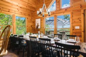 a dining room with a long table and chairs at Premier Log Home Theater, Sauna Hot Tub in McGaheysville