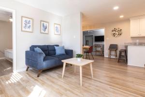 a living room with a blue couch and a table at Rejuvenation and Relaxation in Virginia Beach