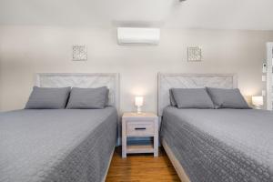 two beds sitting next to each other in a bedroom at Tide Song -10D in Bernard