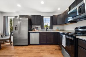a kitchen with stainless steel appliances and wooden cabinets at 37a Orchard Hills Circle in Bernard