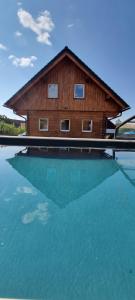 a house sitting on top of a pool of water at Roubenka Olešná na Moravě in Olešná