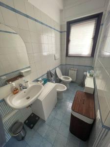 a bathroom with a sink and a toilet and a mirror at Fleming hill apartments - Free Private Parking & Garden in Rome