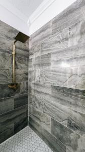 baño con una gran pared de piedra en Staycation Spot, en Orlando