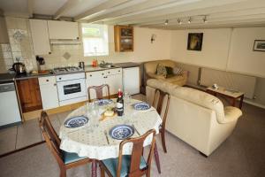 a kitchen and dining room with a table and chairs at Birch Cottage - Tranquil Country Cottage with Indoor Swimming Pool in Haverfordwest +18 photos