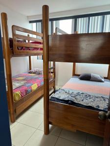 two bunk beds are in a room with at Departamento Punta Centinela frente al mar in Santa Elena +9 photos