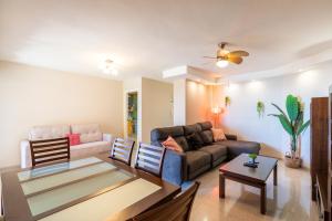 a living room with a couch and a table at Playa Muchavista Terraza Vista Mar in La Venteta +55 photos