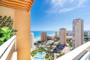 a balcony with a view of the city and the ocean at Playa Muchavista Terraza Vista Mar in La Venteta