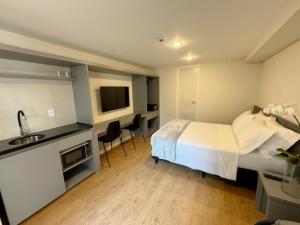 a hotel room with a bed and a sink at Art Lapa Hotel in Rio de Janeiro