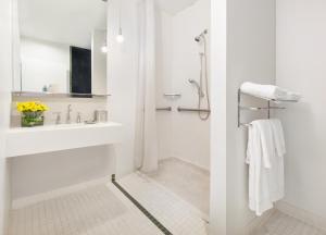 a white bathroom with a sink and a shower at NU Hotel in Brooklyn +28 photos