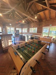 a ping pong table in the middle of a room at Chalet familial entre lac et fôret in Azur