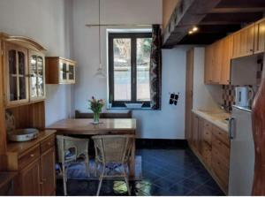 a kitchen with a table and chairs and a window at Maison Al Nocin in Baveno +17 photos