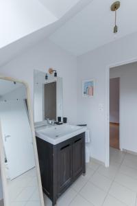a bathroom with a sink and a mirror at AN 19 - Charmante maison a 300m de la mer in Porspoder +35 photos