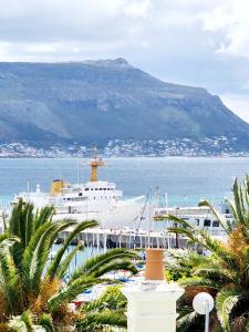 a cruise ship in the water with a mountain at Scenic Blue Studio in Simonʼs Town +16 photos