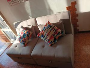 two pillows sitting on a couch in a living room at Residenza Cornicello in Bardolino