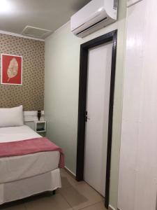 Postel nebo postele na pokoji v ubytování Pousada Iguassu Charm Suites