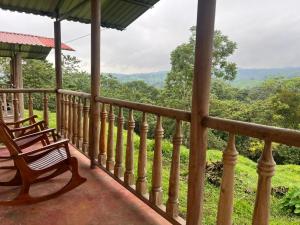 a porch with a bench and a view of the mountains at Cabañas venado 2 in Venado