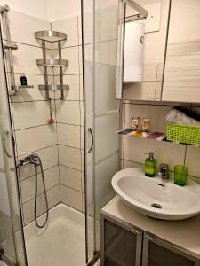 a bathroom with a sink and a shower at Studio apartman Mateo in Rijeka +23 photos