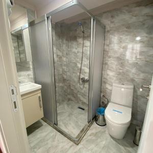 a bathroom with a shower and a toilet at Luu Hotel in Çorlu
