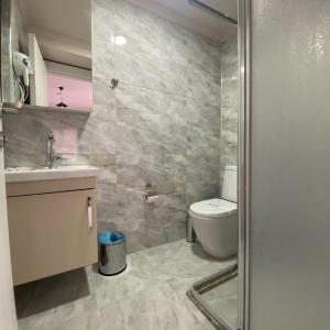 a bathroom with a toilet and a sink at Luu Hotel in Corlu