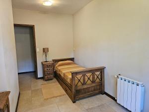 a bedroom with a bed and a dresser in it at Casa SHANTI in Pinamar