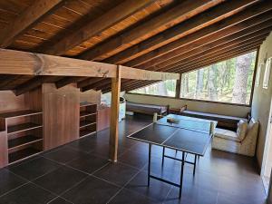 a living room with a table and a bench in a house at Casa SHANTI in Pinamar