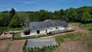 an aerial view of a large house on a field at Bulat-Pestivien Retreat with 4 spacious Bedrooms in Bulat-Pestivien