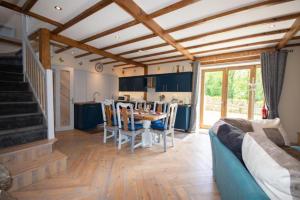 a living room with a blue couch and a table at Bulat-Pestivien Retreat with 4 spacious Bedrooms in Bulat-Pestivien