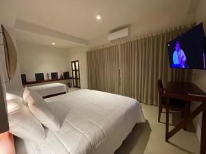 Postel nebo postele na pokoji v ubytování Cuatro Lunas Hotel Boutique