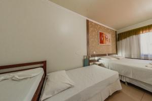 Postel nebo postele na pokoji v ubytování Pousada Iguassu Charm Suites
