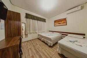 Postel nebo postele na pokoji v ubytování Pousada Iguassu Charm Suites