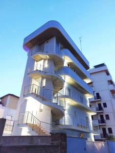 a white building with balconies on the side of it at Sweet Home & Wellness Luxury Apartment in Nettuno