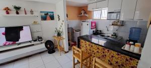 a kitchen with a table and a counter top at Apartamento Enseada Beach Residence completo in Cabo de Santo Agostinho