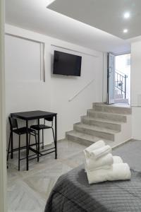 TV a/nebo společenská místnost v ubytování La Corte Guest House
