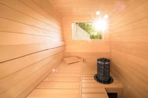 a small sauna with a window in a wooden wall at TRI VODY Demänovská Dolina in Liptovský Mikuláš +230 photos