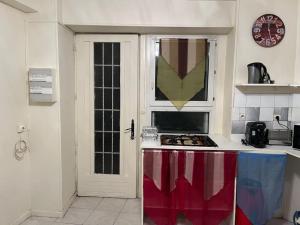 a kitchen with a stove and a white door at Appartement en centre-ville in Roissy-en-France +4 photos