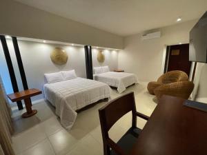 Postel nebo postele na pokoji v ubytování Cuatro Lunas Hotel Boutique
