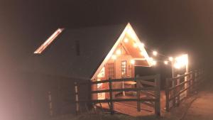 a house with lights on the side of it at night at Vilare's da Mantiqueira in Queimada +8 photos