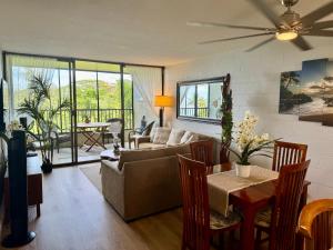 a living room with a couch and a table at Direct Oceanfront Mauna Loa Shores Honu Elua #508 next to Carlsmith Beach park, Hilo HI in Hilo